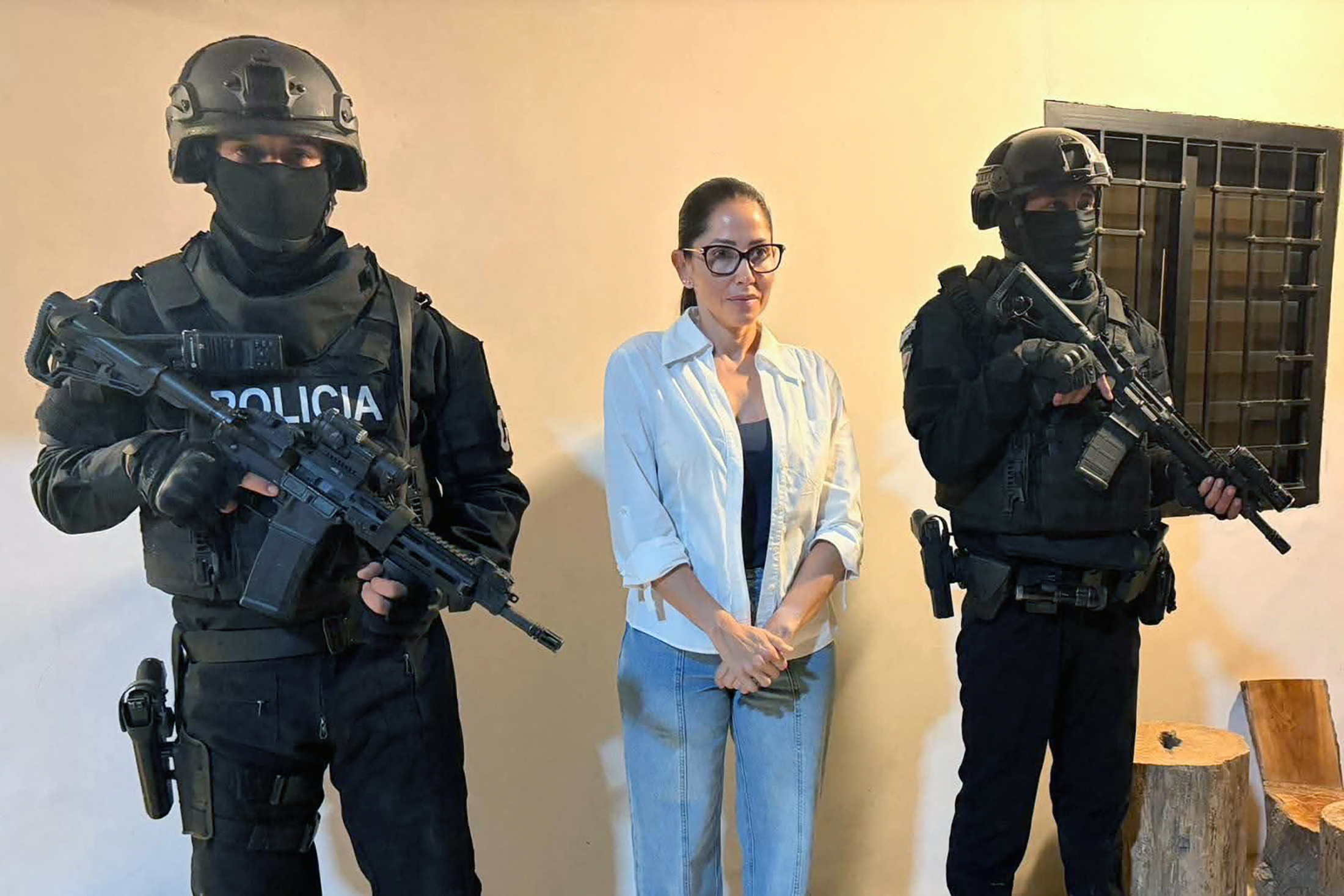 This handout picture released by Ecuador's Police Organized Crime Unit (ULCO) on October 23, 2026, shows former Ecuadorian presidential candidate Luisa Gonzalez (C) of the Citizens' Revolution party under police guard during her arrest and the search of her home in Canuto, Ecuador.