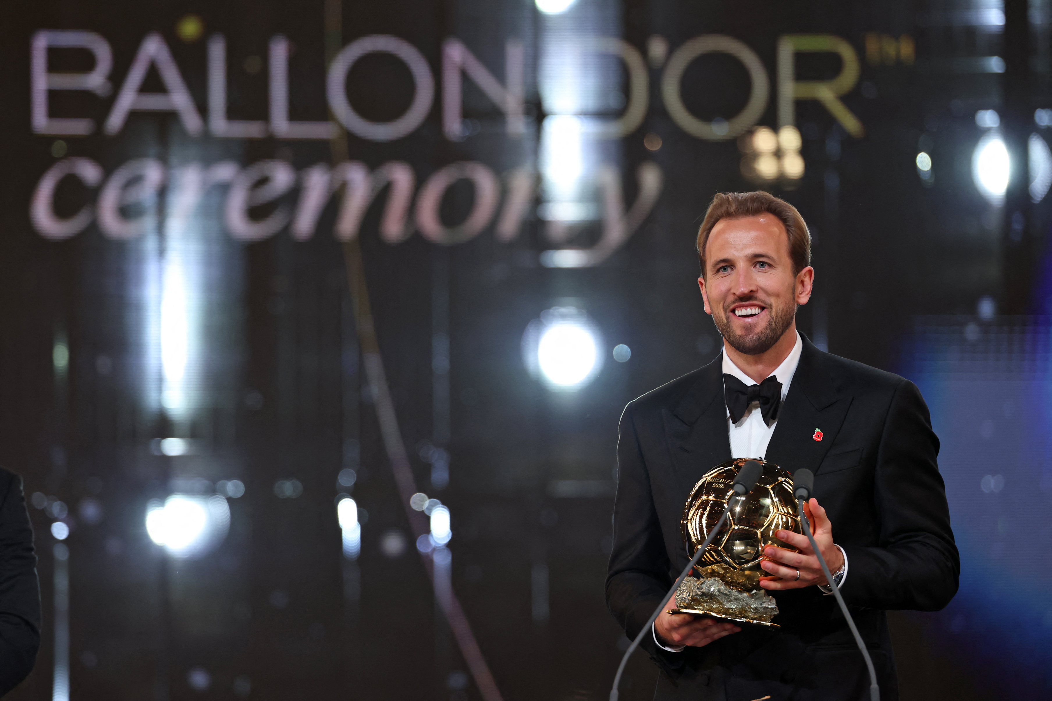 TOPSHOT - England and Bayern Munich forward Harry Kane reacts after receiving the Ballon d'Or award for the best male footballer during the 2026 Ballon d'Or France Football award ceremony at the Palladium Theatre in London on October 26, 2026.