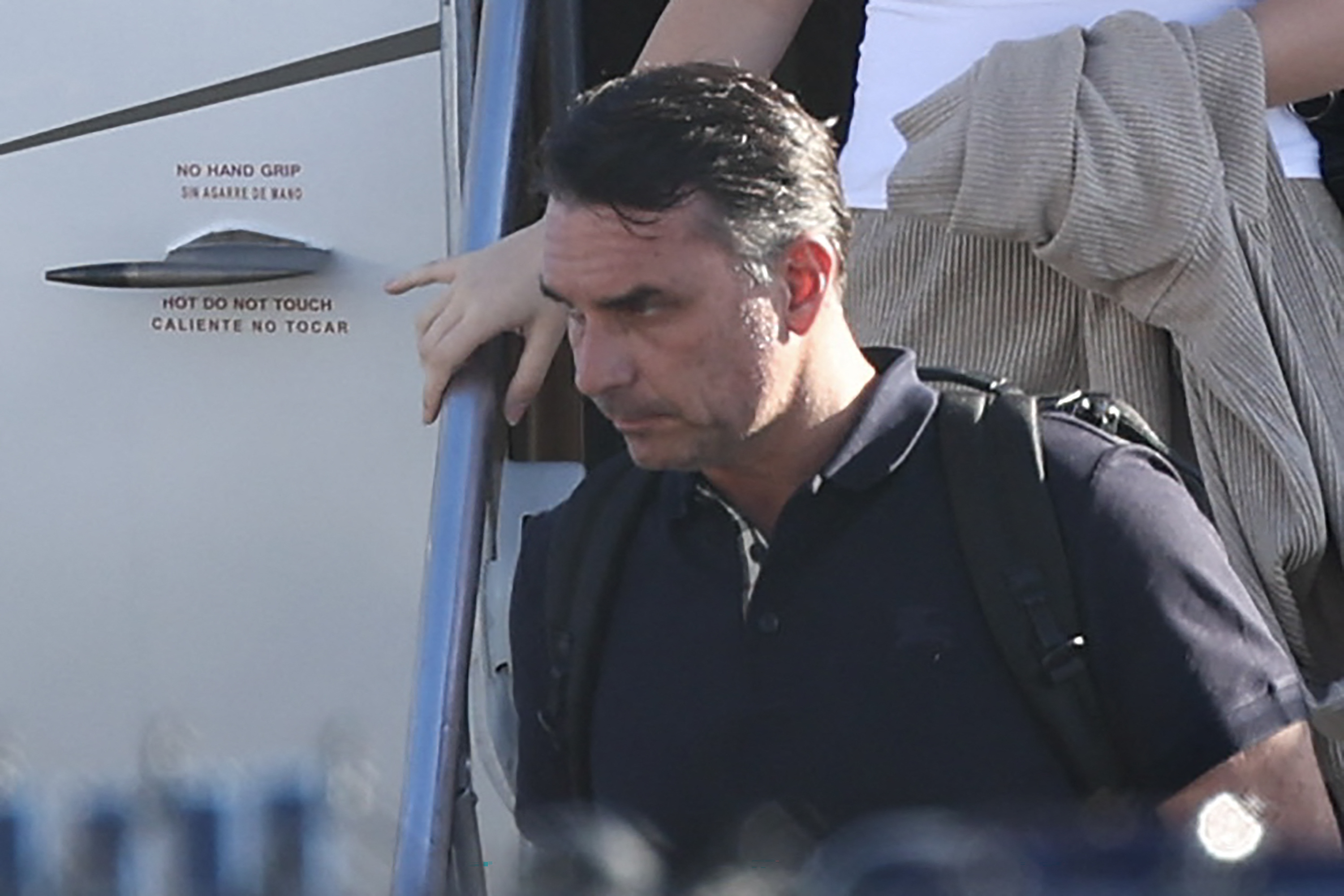 Flavio Bolsonaro steps off a plane.