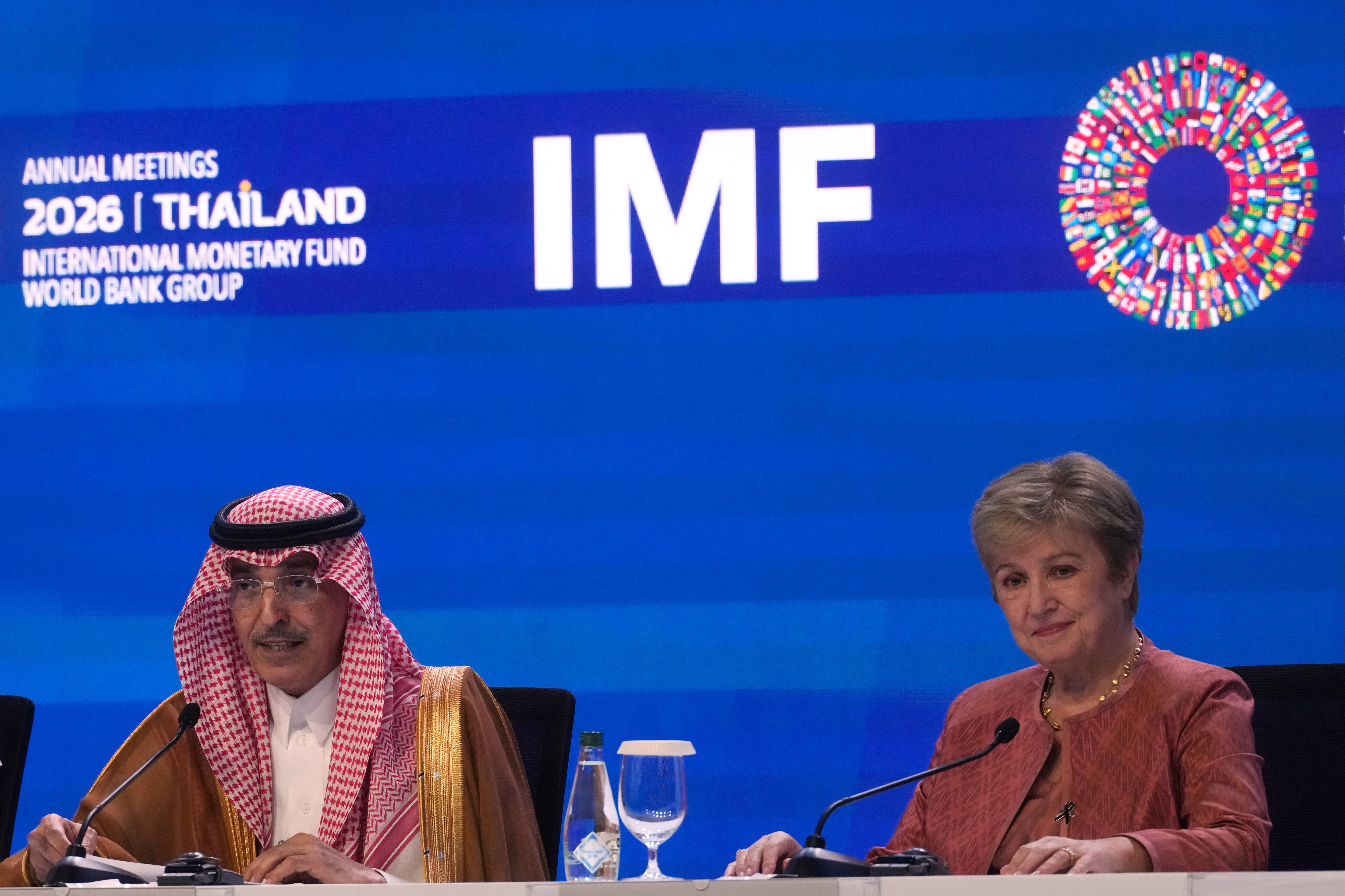 International Monetary and Financial Committee (IMFC) Chair and Saudi Arabia's Finance Minister Mohammed Al-Jadaan, left, speaks as International Monetary Fund (IMF) Managing Director Kristalina Georgieva listens at a news conference following the International Monetary and Financial Committee (IMFC) meeting during the annual meetings of the IMF and the World Bank Group in Bangkok, Thailand, Saturday, Oct. 17, 2026. (AP Photo/Sakchai Lalit)