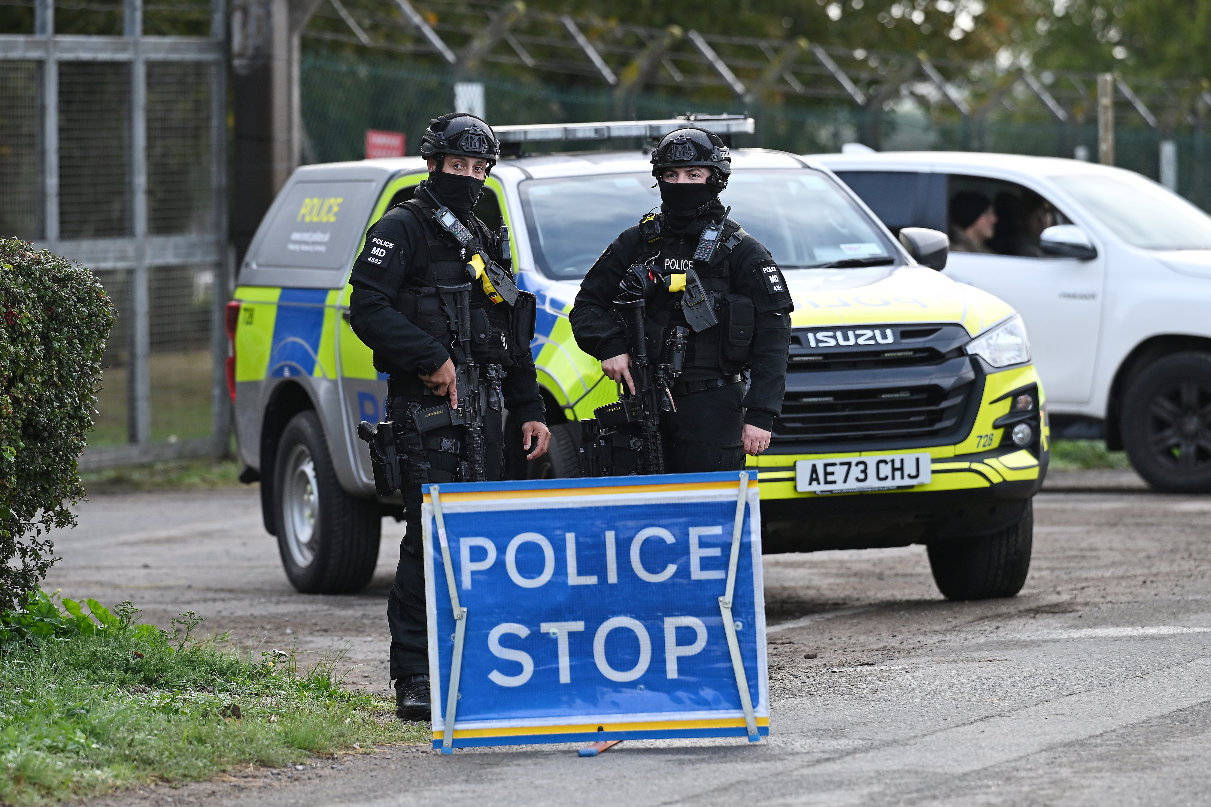 FAIRFORD, ENGLAND - SEPTEMBER 28: Armed police maintain road blocks and security checks around RAF Fairford on September 28, 2026 in Fairford, England. Police declared a major incident on Sunday following the arrest of five men on suspicion of committing offences under the Explosives Act and preparation of a terrorist act near RAF Fairford, a military base that hosts U.S. Air Force bombers involved in the Iran conflict. Eighty-five homes were evacuated from Whelford, a village about one mile from RAF Fairford, as the Army's specialist explosive ordnance disposal team investigated vehicles in the area. (Photo by Leon Neal/Getty Images)