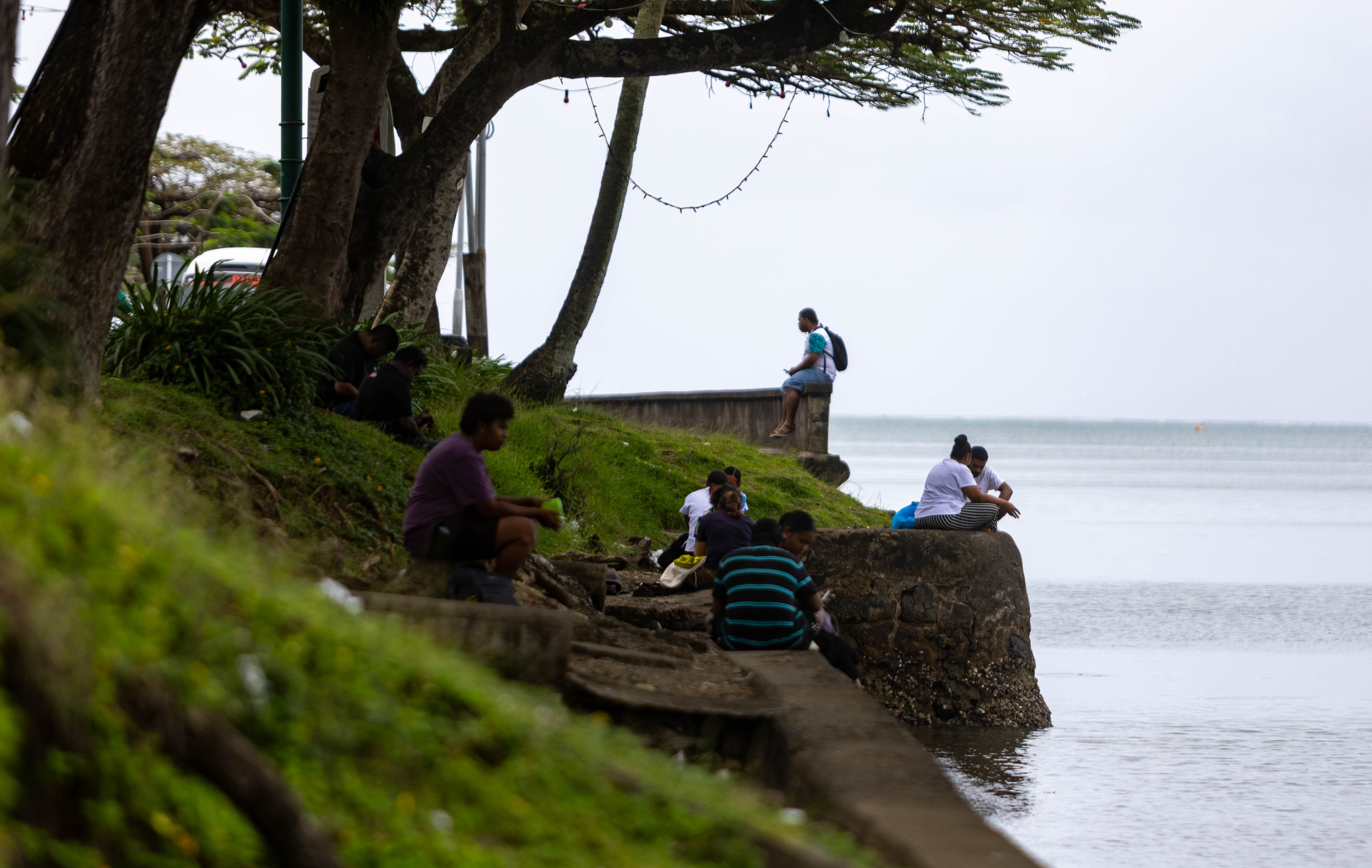 SUVA, FIJI - OCTOBER 02: A general view of people sitting by the water in Suva City on October 02, 2026 in Suva, Fiji. Fiji has declared a national health emergency as HIV infections surge, with 2,016 new cases diagnosed in 2025, up 27% from the previous year, according to UNAids. More than 42% of new cases that year were linked to shared injecting equipment, and health officials hope the emergency measures will expand testing, treatment and access to sterile syringes. (Photo by Pita Simpson/Getty Images)
