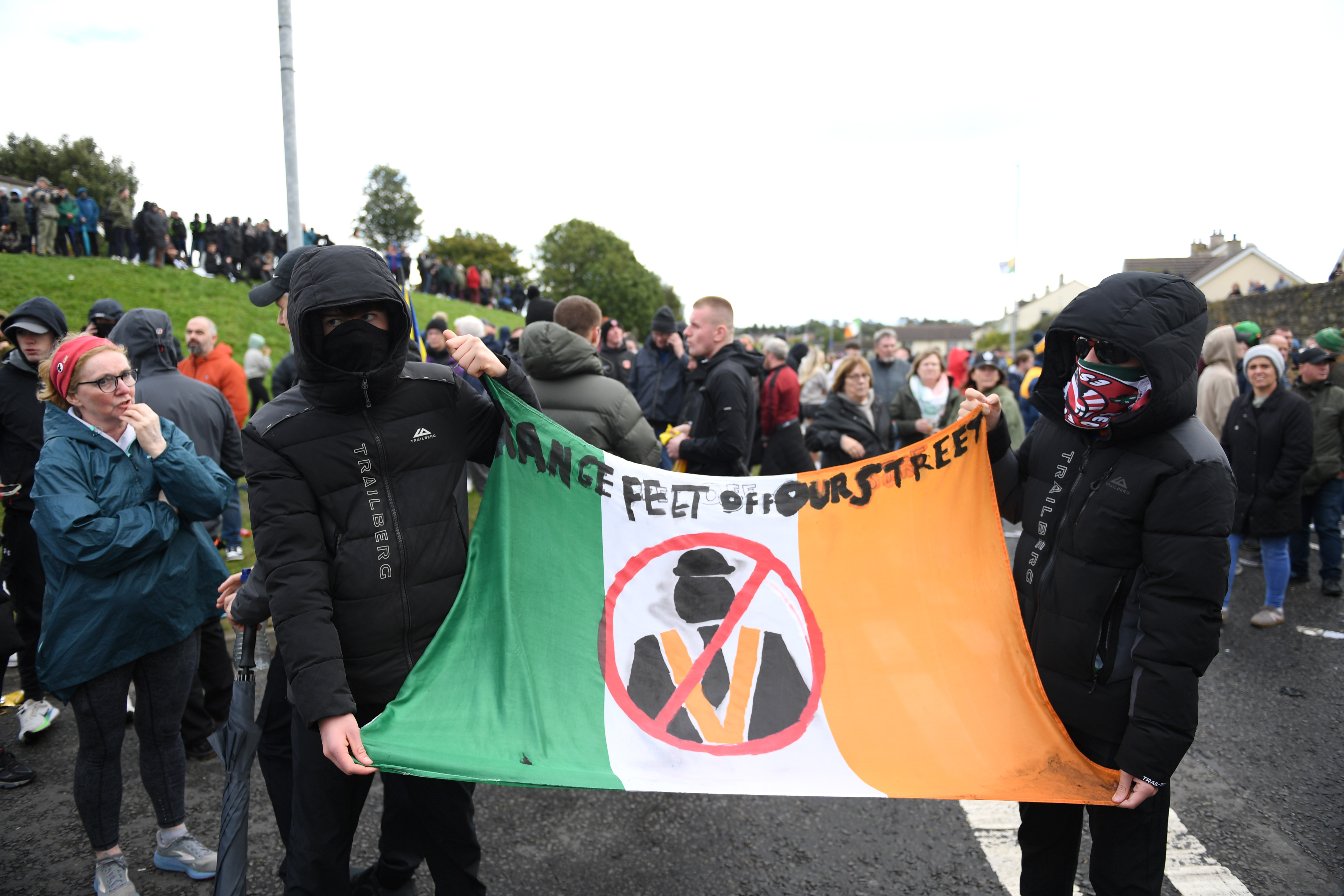 PORTADOWN, NORTHERN IRELAND - SEPTEMBER 27: Protesters hold banners as they gather on Garvaghy Road on September 27, 2026 in Portadown, Northern Ireland. Following a string of legal challenges, the High Court has ruled the contentious Orange Order's march could go ahead today, following a route down Portadown's Garvaghy Road for the first time in nearly three decades. The Drumcree Parade has been denied permission since 1998 to follow what the Orange Order loyalists say is their traditional route down the primarily nationalist Garvaghy Road, but in August the High Court ruled that the commission could not impose restrictions on the parade due to a procedural error. The long-standing dispute over the parade has previously led to sectarian violence dating back to The Troubles in Northern Ireland. (Photo by Charles McQuillan/Getty Images)