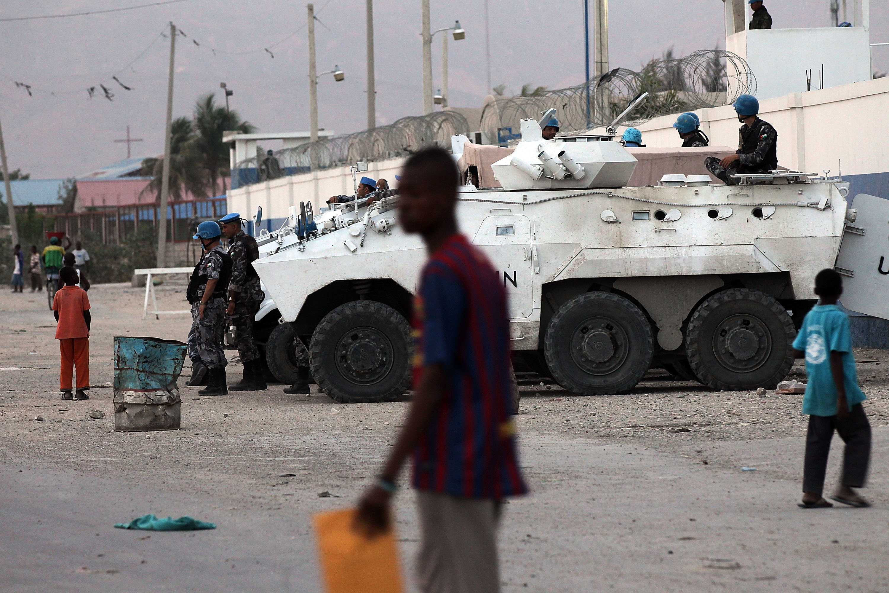 PORT-AU-PRINCE, HAITI - MARCH 08: United Nations soldiers keep guard on the outskirts of Cite Soleil as tensions over the current Haitian presidents nationality spark unrest in the capital on March 7, 2012 in Port-au-Prince, Haiti. Haitian President Michel Martelly is trying to quell rumors over his nationality after he was accused of not being a Haitian citizen. At a nationally televised news conference on Thursday, the president showed reporters his blue Haitian passport and U.S. ambassador to Haiti Kenneth Merten stated that Martelly is not a U.S. citizen. Two years after the 7.0 magnitude quake that killed an estimated 316,000 people, much of Haiti is still in a crisis situation with tens of thousands living in tent camps in and around Port-au-Prince. (Photo by Spencer Platt/Getty Images)