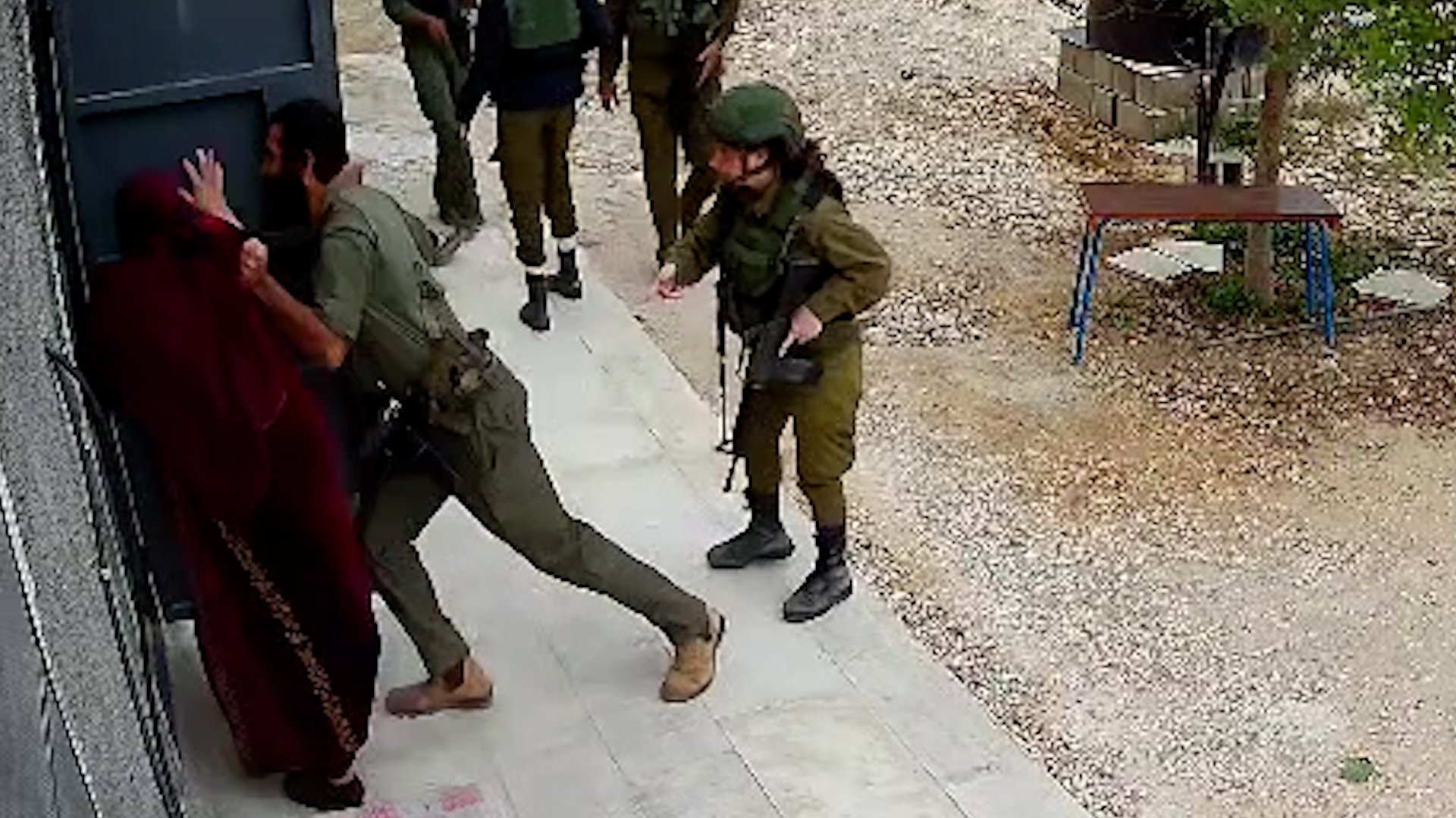 Israeli soldier assaulting a Palestinian woman