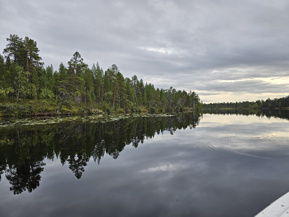 A scenic view of Lake Inari in Finnish Lapland shows clouds and trees in the background in September 2025