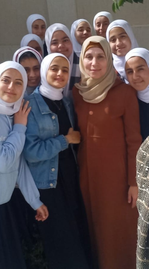 Sara Rayan (right) takes a selfie with her classmates at Muscat Secondary School for Girls in Nuseirat, Gaza, in June 2023
