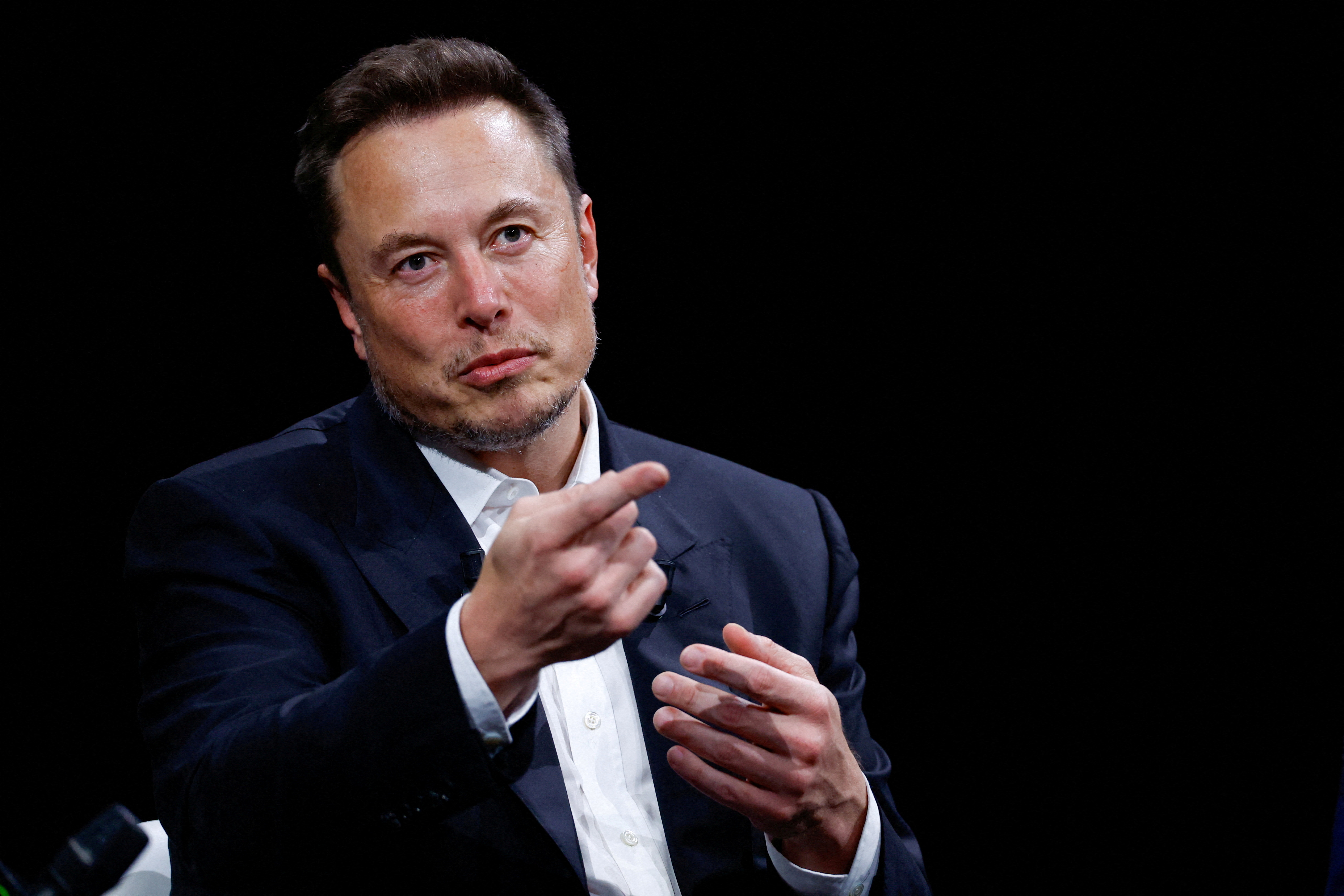 FILE PHOTO: Elon Musk, Chief Executive Officer of SpaceX and Tesla and owner of X, formerly known as Twitter, gestures as he attends the Viva Technology conference dedicated to innovation and startups at the Porte de Versailles exhibition centre in Paris, France, June 16, 2023. REUTERS/Gonzalo Fuentes/File Photo