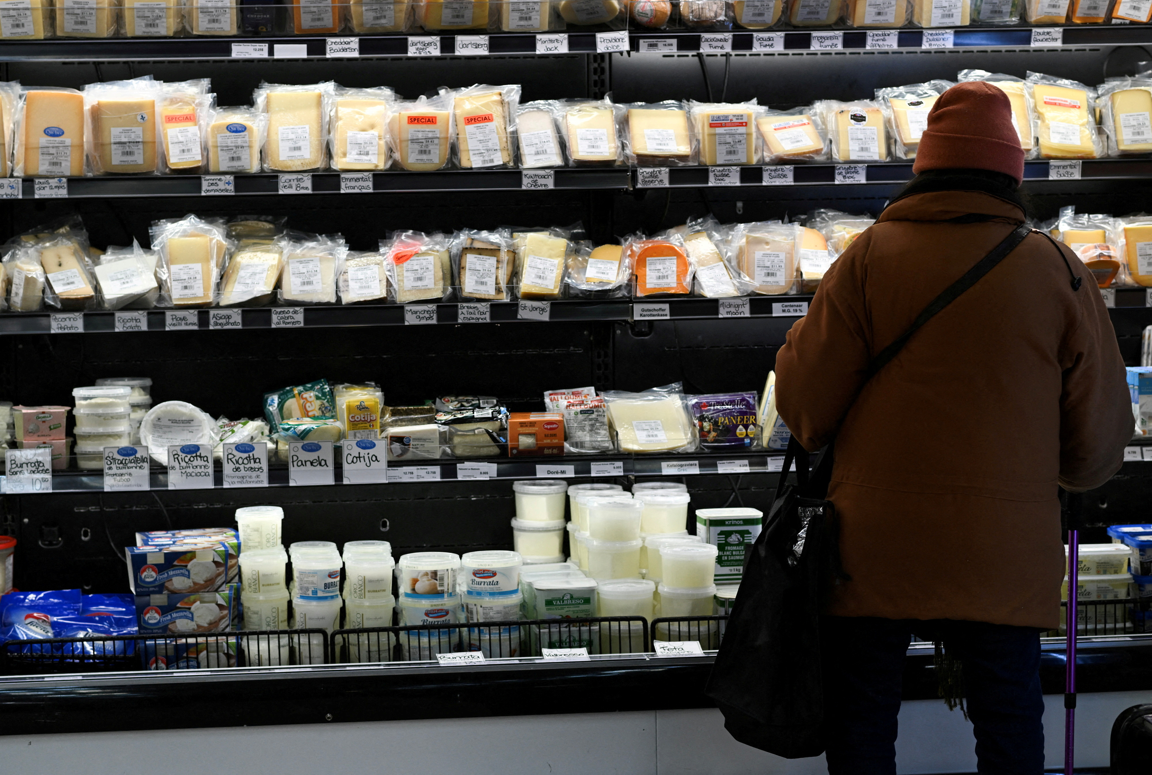 FILE PHOTO: A person shops for cheese at a cheese shop at Atwater Market in Montreal, Quebec, Canada March 9, 2025. REUTERS/Graham Hughes/File Photo