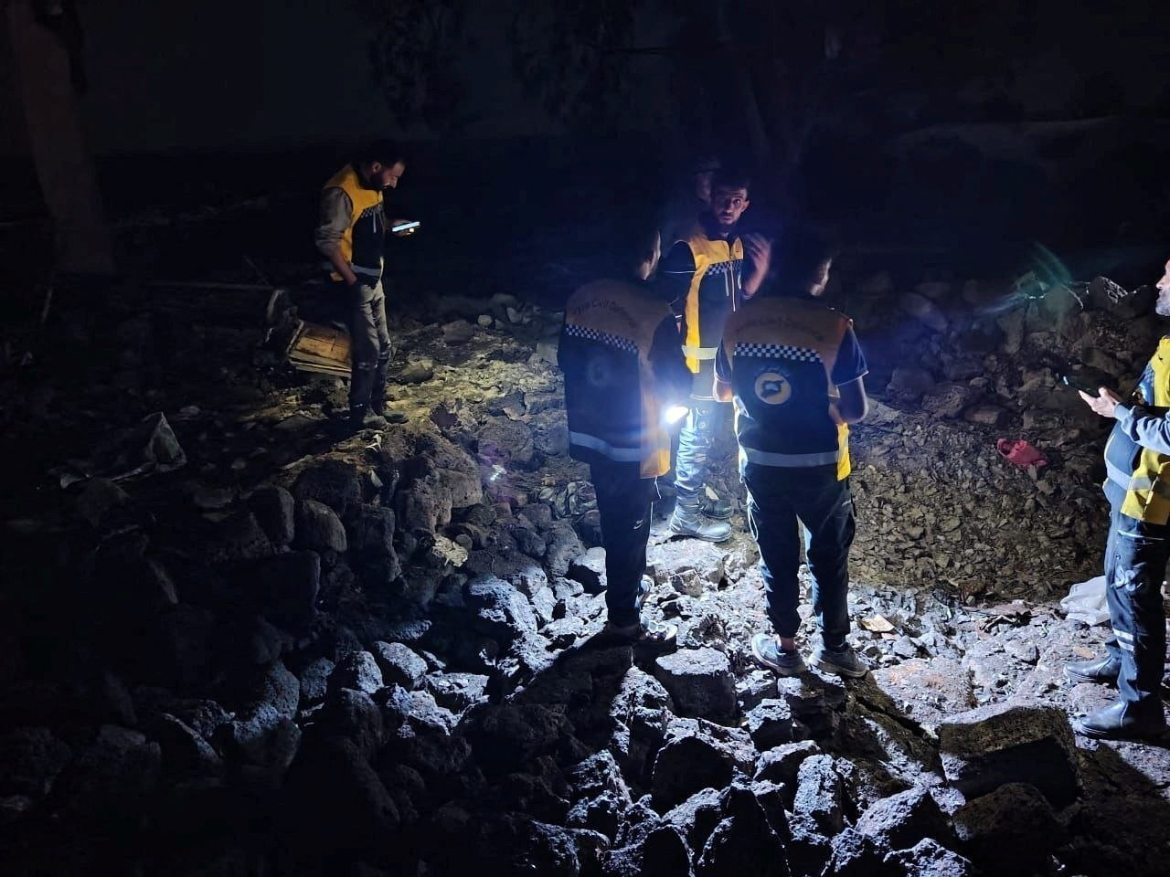 Members of the Syrian civil defence group known as the White Helmets take part in rescue operations.