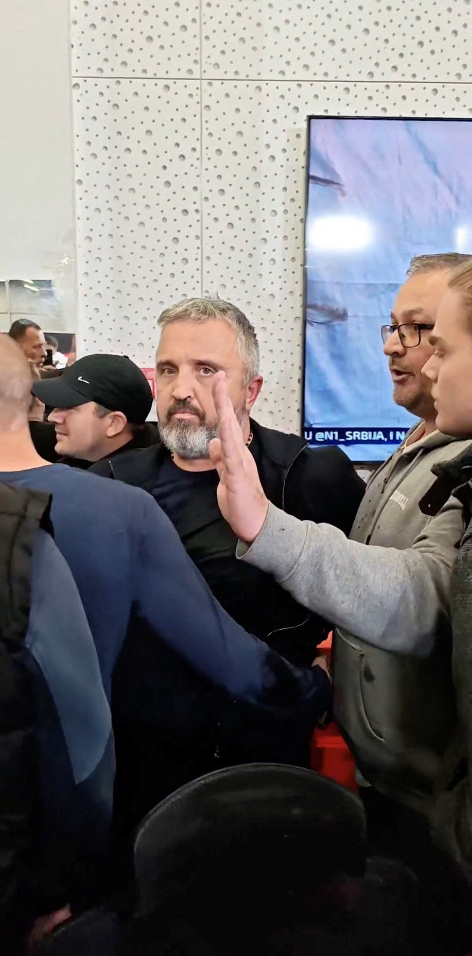 Protestors confront editor of Informer TV, Dragan Vucicevic, in media's Belgrade office, Serbia, October 26, 2026 in this screengrab obtained from a social media video published on TikTok @veljars/via REUTERS THIS IMAGE HAS BEEN SUPPLIED BY A THIRD PARTY. MANDATORY CREDIT. Verification lines: The location was verified as the office of Informer TV in Belgrade, Serbia, from the interior door, staircase, and columns, which matched archive imagery. The date was verified by metadata of other videos from the source and media reports of the event. The person shown in the video was identified as Dragan Vucicevic from his facial features and hair, which matched archive imagery.